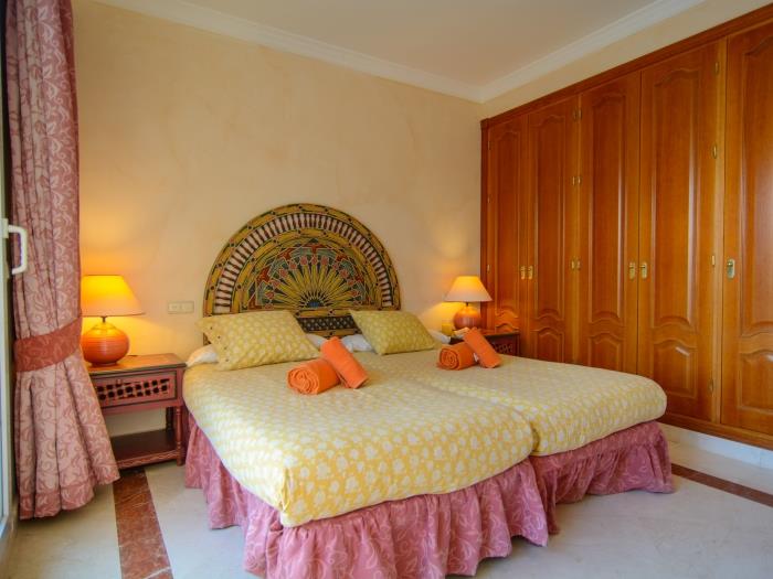 Two single beds in master bedroom with wardrobes