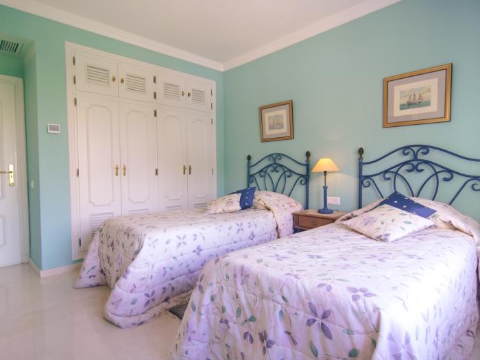 Bedroom with two single beds and en suite bathroom