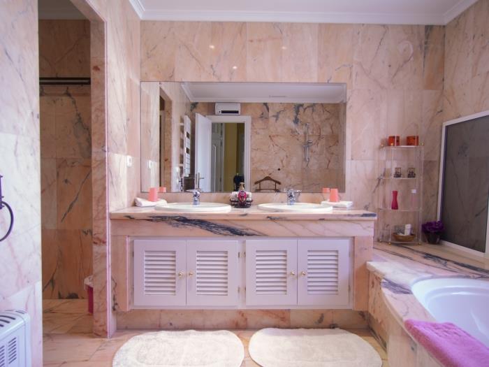 En suite bathroom with double sink, bathtub