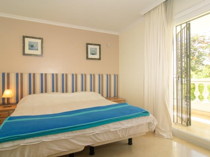 Bedroom with large wardrobes, sliding glass door