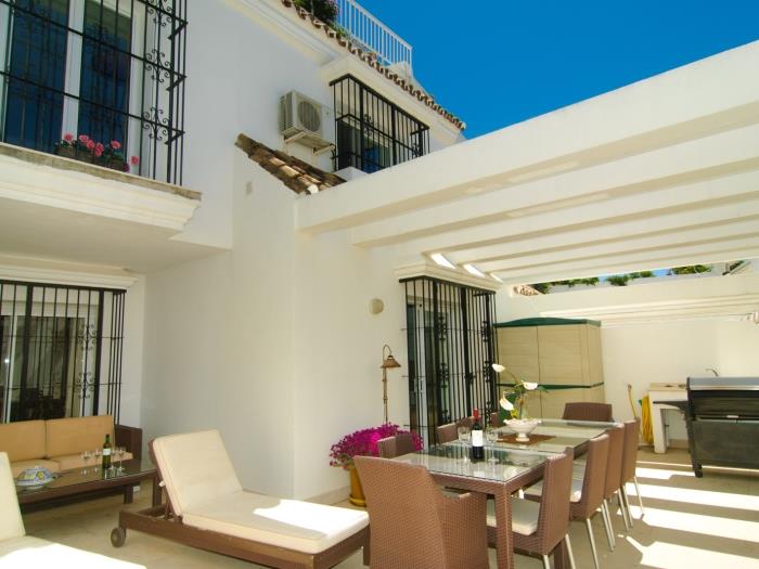 Dining table, lounge area with a sofa, sunloungers