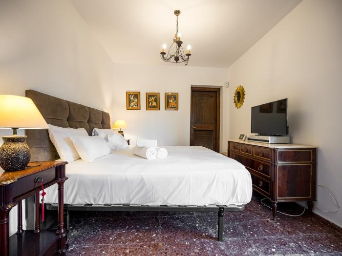 Master bedroom with flat screen TV, wardrobe