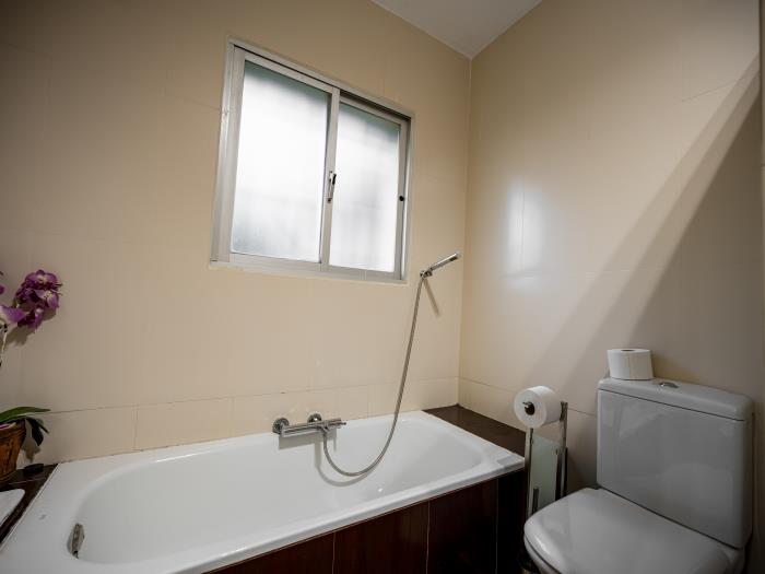 Double bed in bedroom with large wardrobes