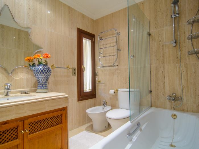 En suite bathroom with bathtub w/ shower, sink