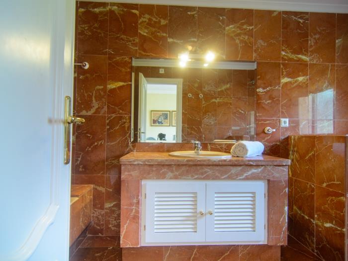 Bathtub with shower, sink, bidet in bathroom