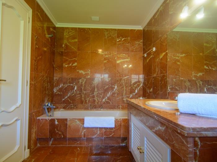 Bathroom w/ bathtub with shower, sink, bidet