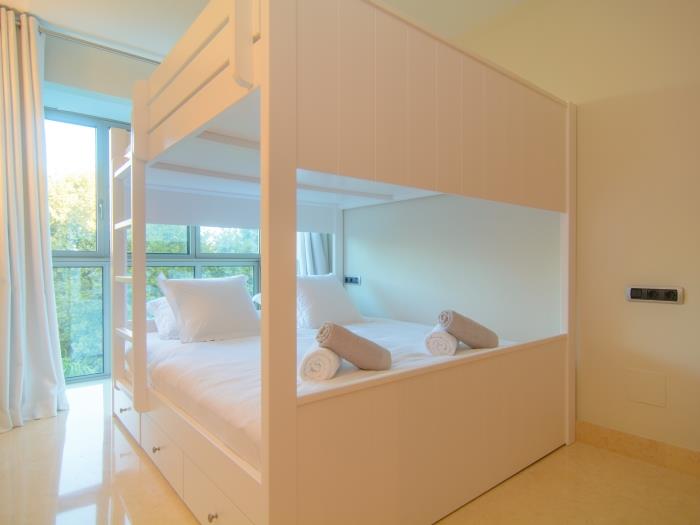 Guest bedroom with bunk bed and large windows
