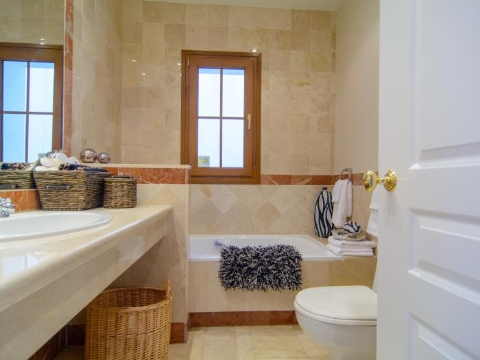 En suite bathroom with bathtub w/ shower and bidet