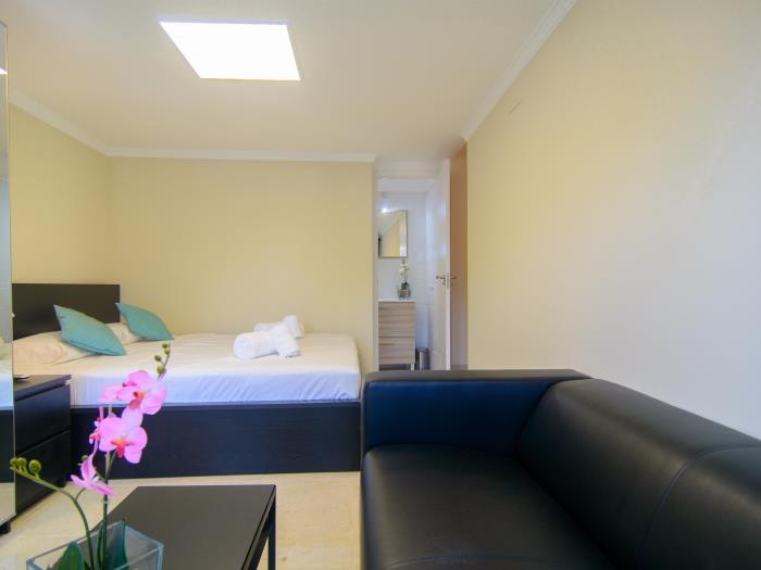 Guest bedroom with leather armchair and table