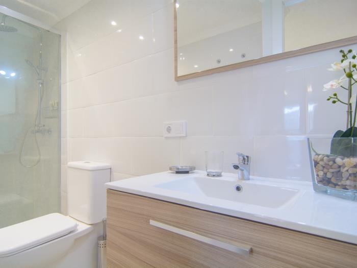 En suite bathroom with walk in shower sink, toilet