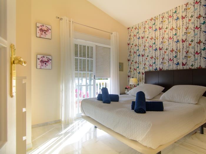 Guest bedroom with double bed, exit to terrace