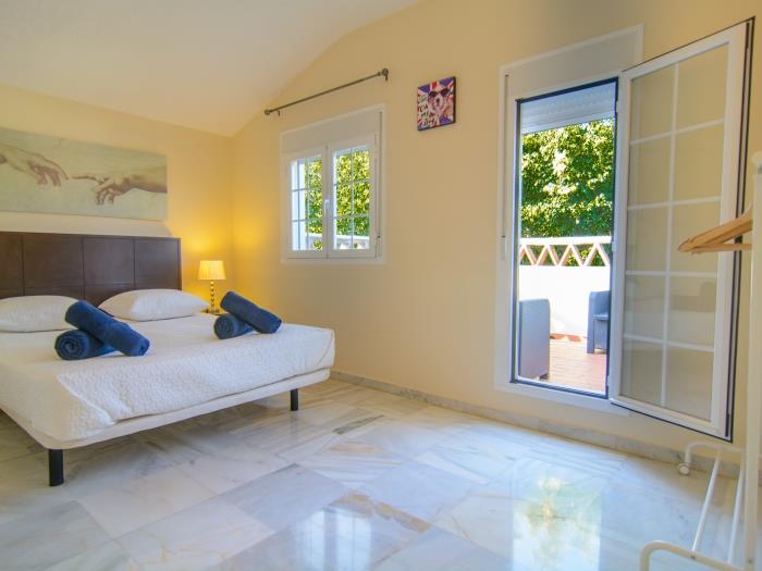 Guest bedroom with double bed, exit to terrace