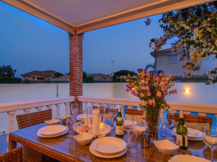 Six sitter dining table on terrace with pool view