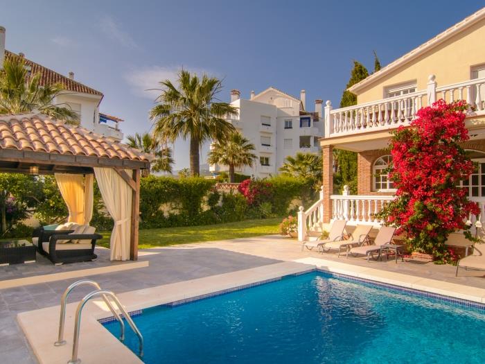 Pergola by the pool with lounge area in the shade