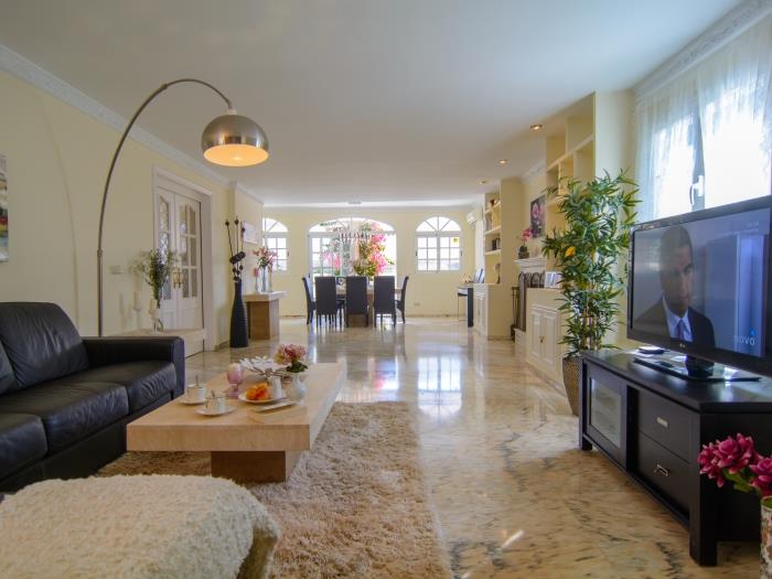 Lounge area with flat screen LG TV, coffee table