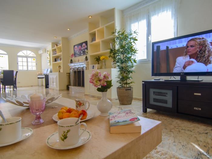 Coffee table and flat screen LG TV in lounge area