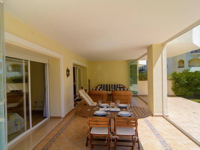 Dining area on terrace, wooden round table for 4