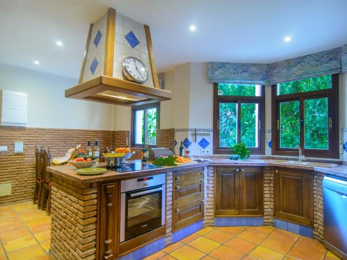 Fully equipped kitchen with brick wall details