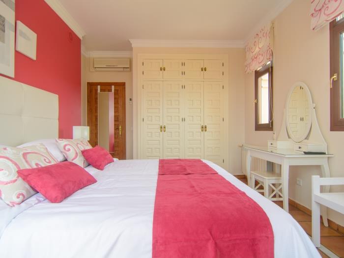 Large recessed wooden wardrobes in guest bedroom