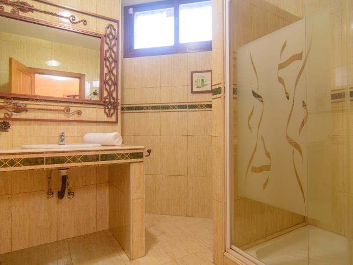 En suite bathroom with walk in shower and 2 sinks