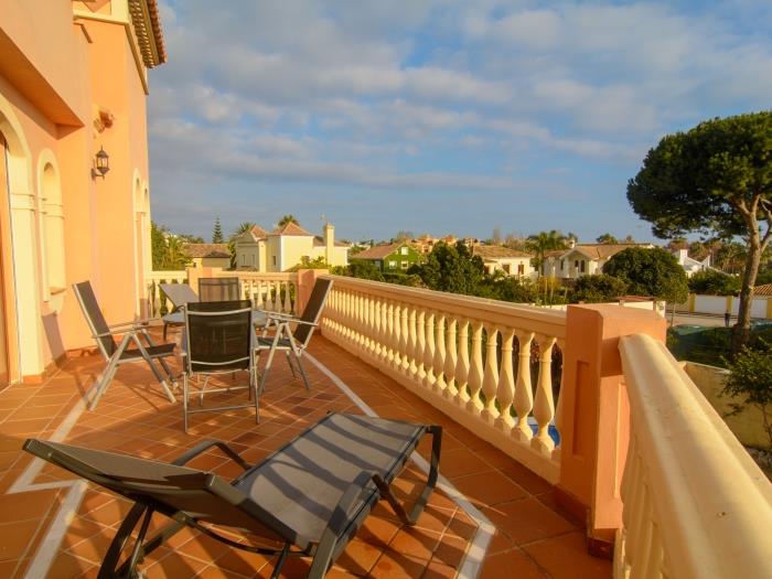 Terrace w loungers on first level with pool view