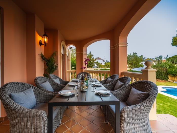 Terrace with spacious dining table with pool view