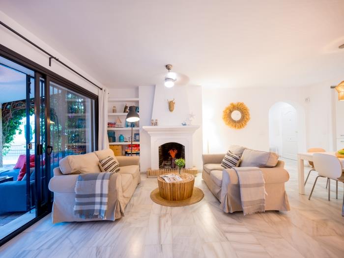 Living room with marble tiles, fireplace and table