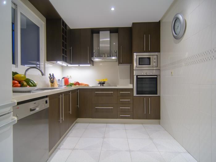 Neat kitchen equipped with all needed appliances