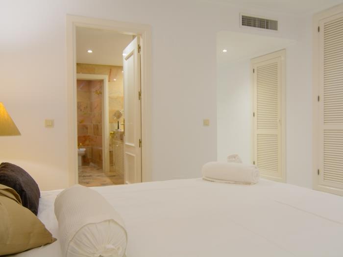 Spacious wardrobes and double bed in bedroom