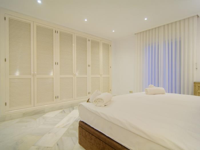 Double bed and spacious wardrobes in bedroom