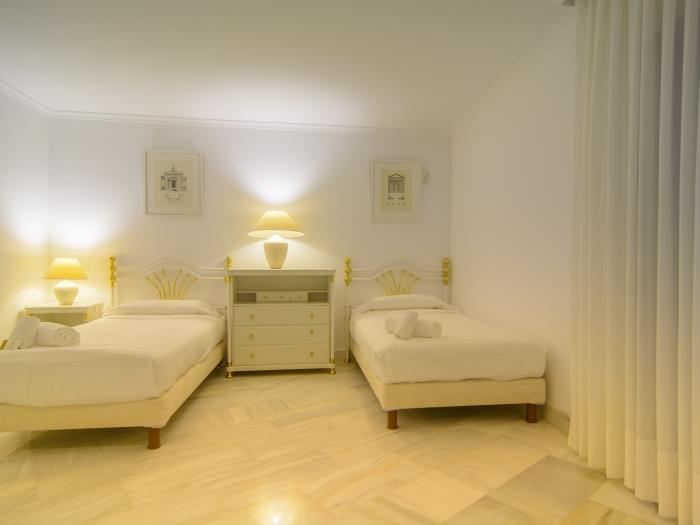 Two single beds in family bedroom with drawer