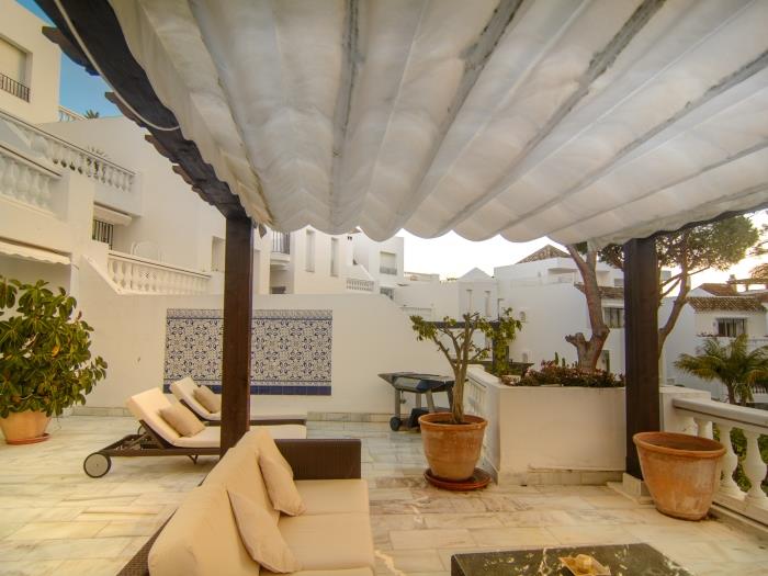 Covered sitting area on spacious terrace