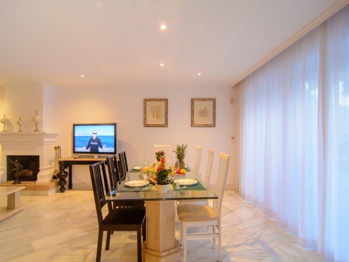 Dining area with table for eight, flat screen TV