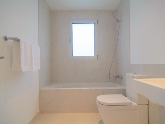 Bathtub with shower and window in family bathroom