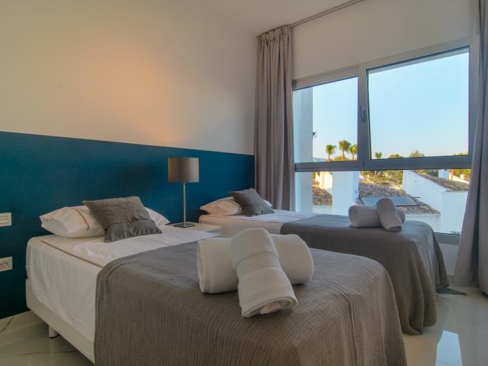 Guest bedroom with double bed and windows