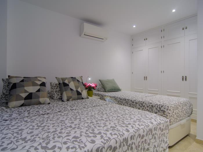 Single bed and double bed in bedroom with wardrobe