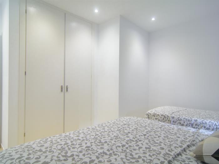 Guest bedroom with wardrobe and large bed