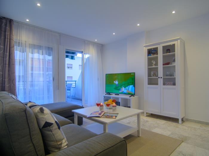 Living room with sofa, coffee table and TV