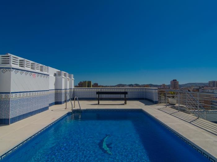 Rooftop pool with view over the harbor and mountains