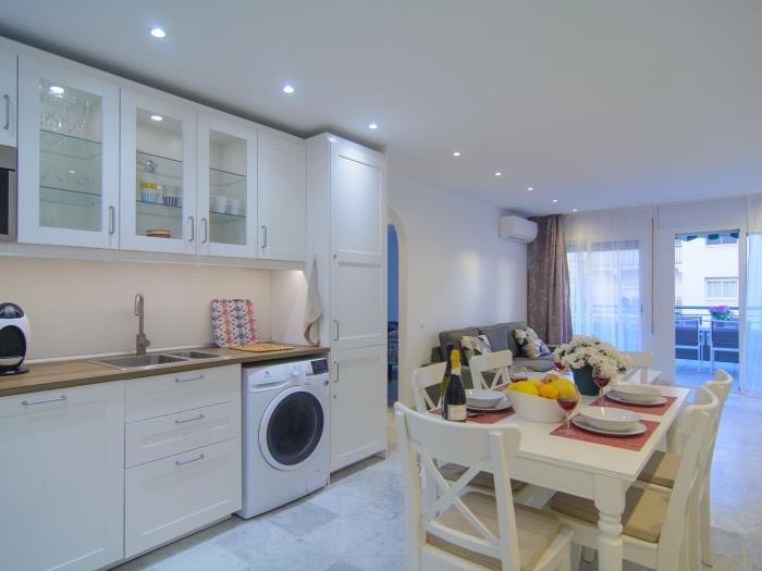 Living room with white wooden table for six