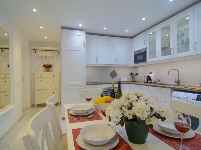 Neat design open plan kitchen with dining table