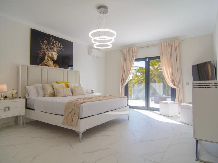 Master bedroom with double bed, access to terrace upstairs, chest of drawers, TV