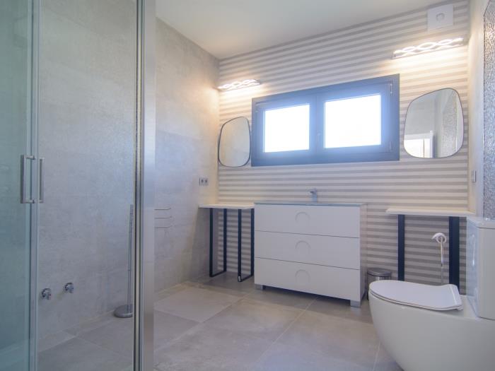 Family bathroom with walk in shower, sink, toilet, window