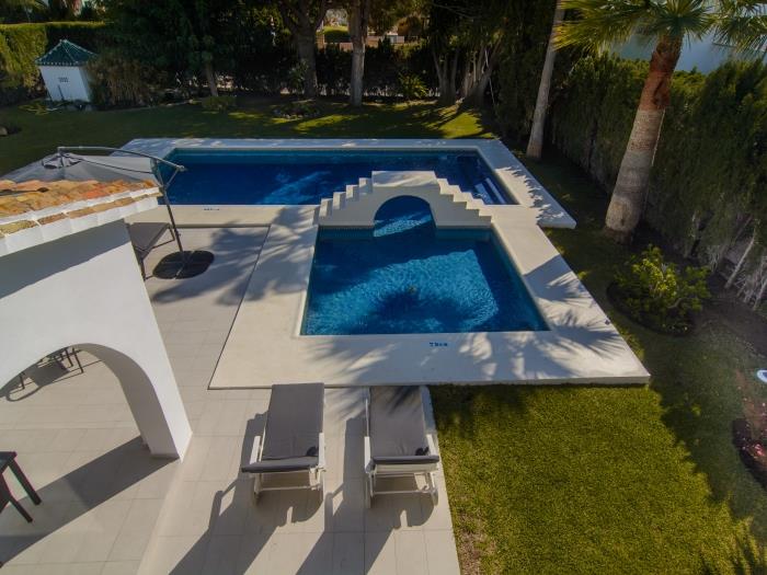 Small terrace on the first floor with pool view and coffee table