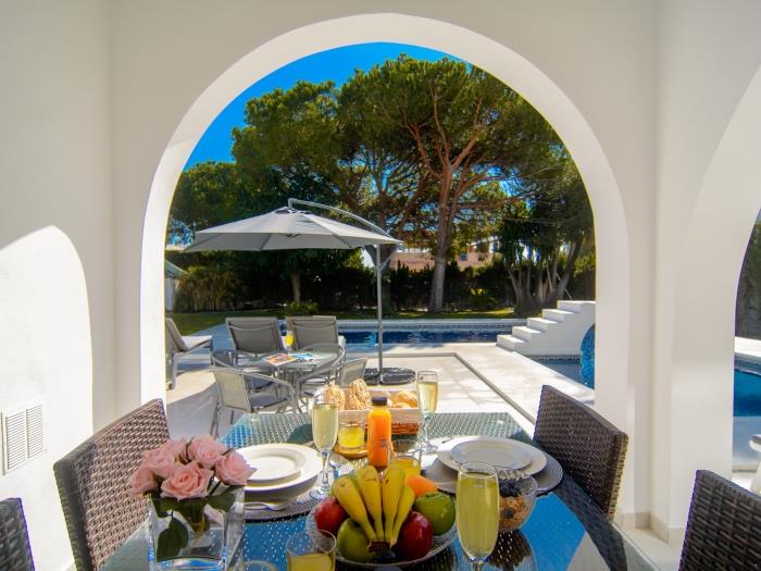 Rattan furniture on main terrace with pool views