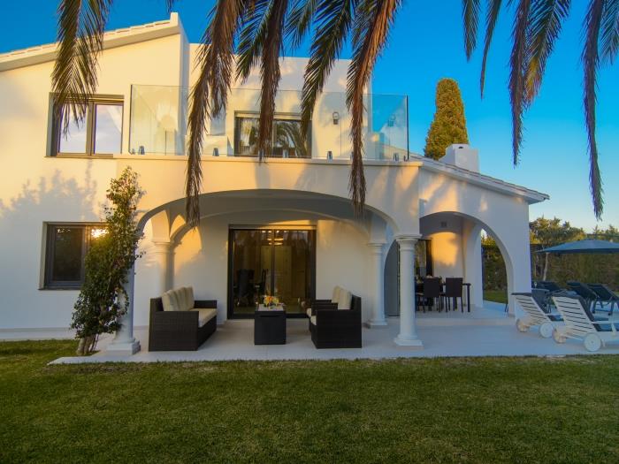 Elegant villa with terraces, pool, sun loungers and umbrella
