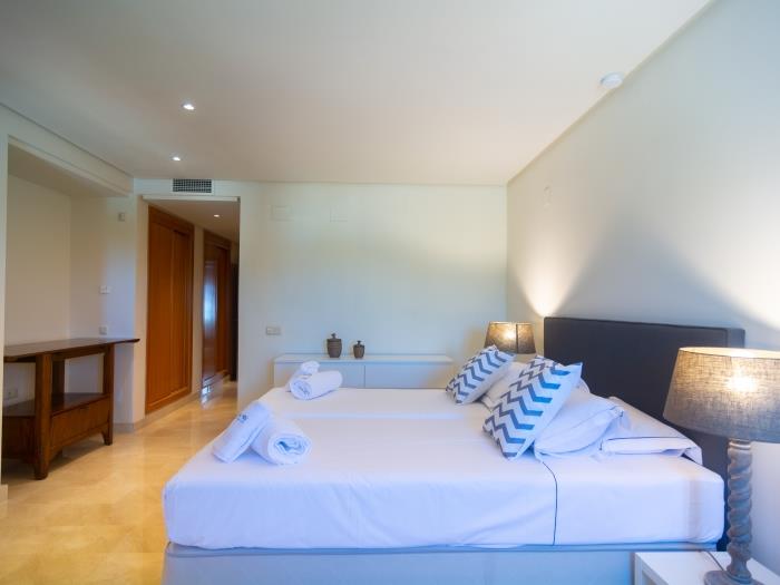Two single beds (90x200cm), nightstands with lamps with shade and a wardrobe