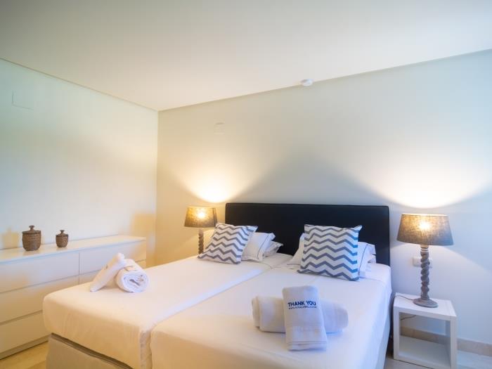 Two single beds (90x200cm), nightstands with lamps with shade and a wardrobe