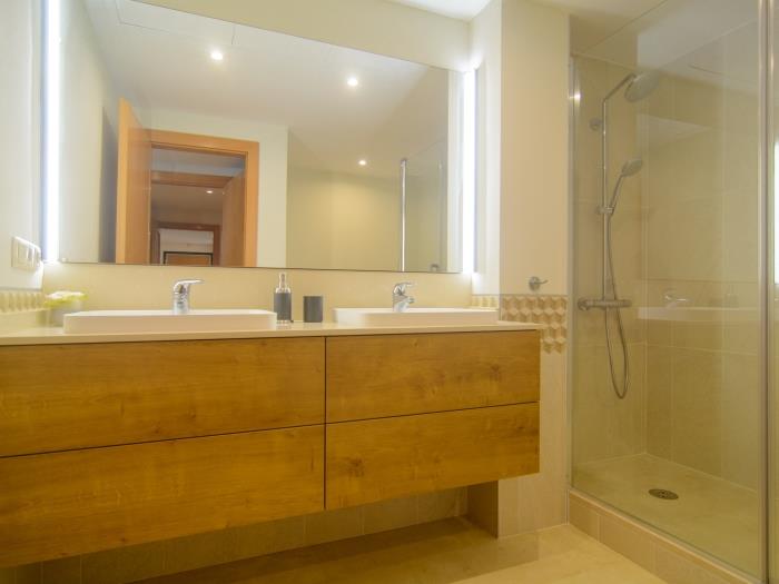 En suite bathroom with double sink,  walk in shower, bidet and toilet
