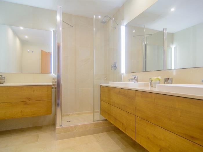 En suite bathroom with double sink,  walk in shower, bidet and toilet